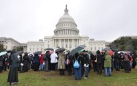 The 13th and 14th stations on the Way of the Cross were on the wet, muddy lawn of the U.S. Capitol